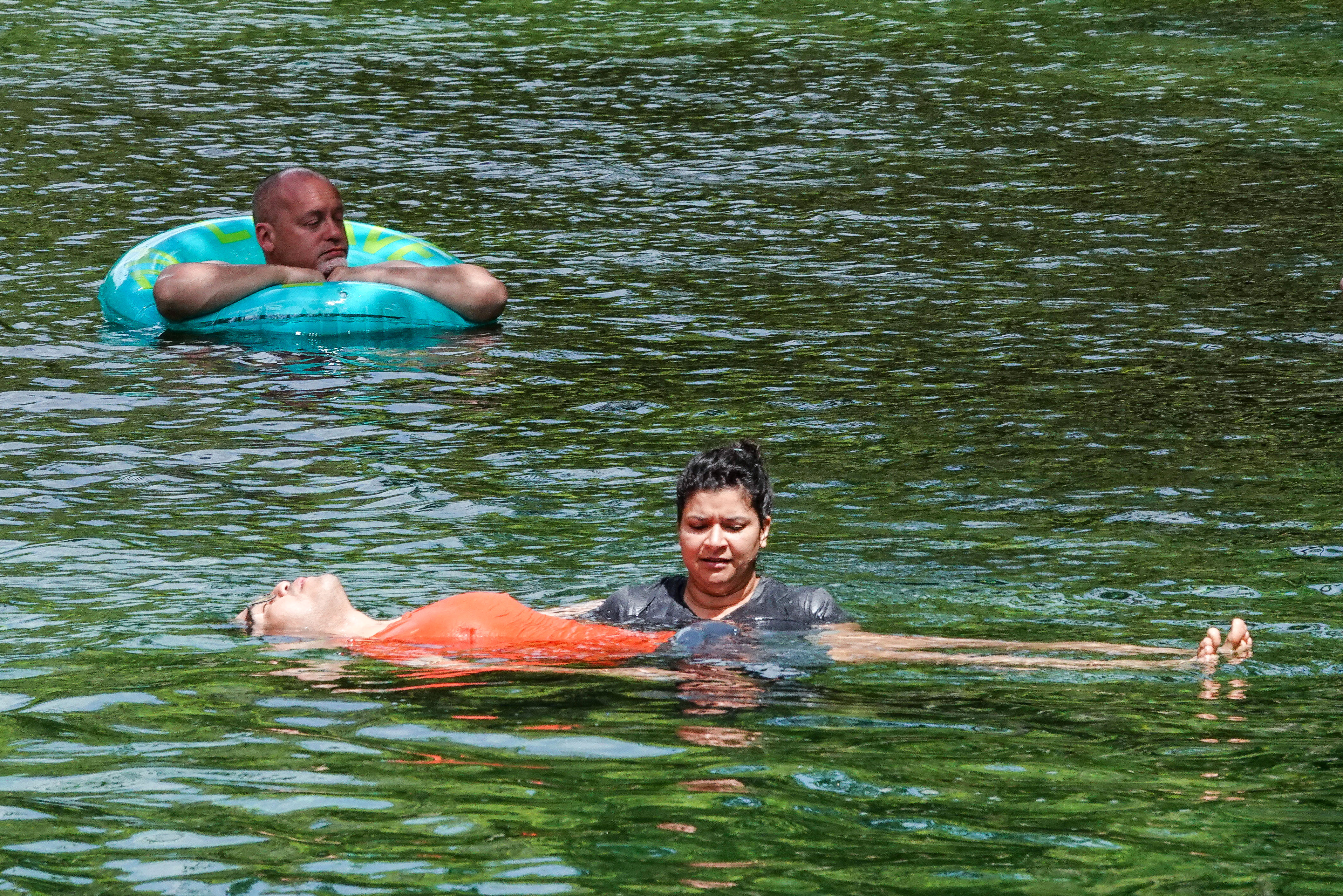 ENJOYING THE BLUE â Tubers and swimmers float down the...