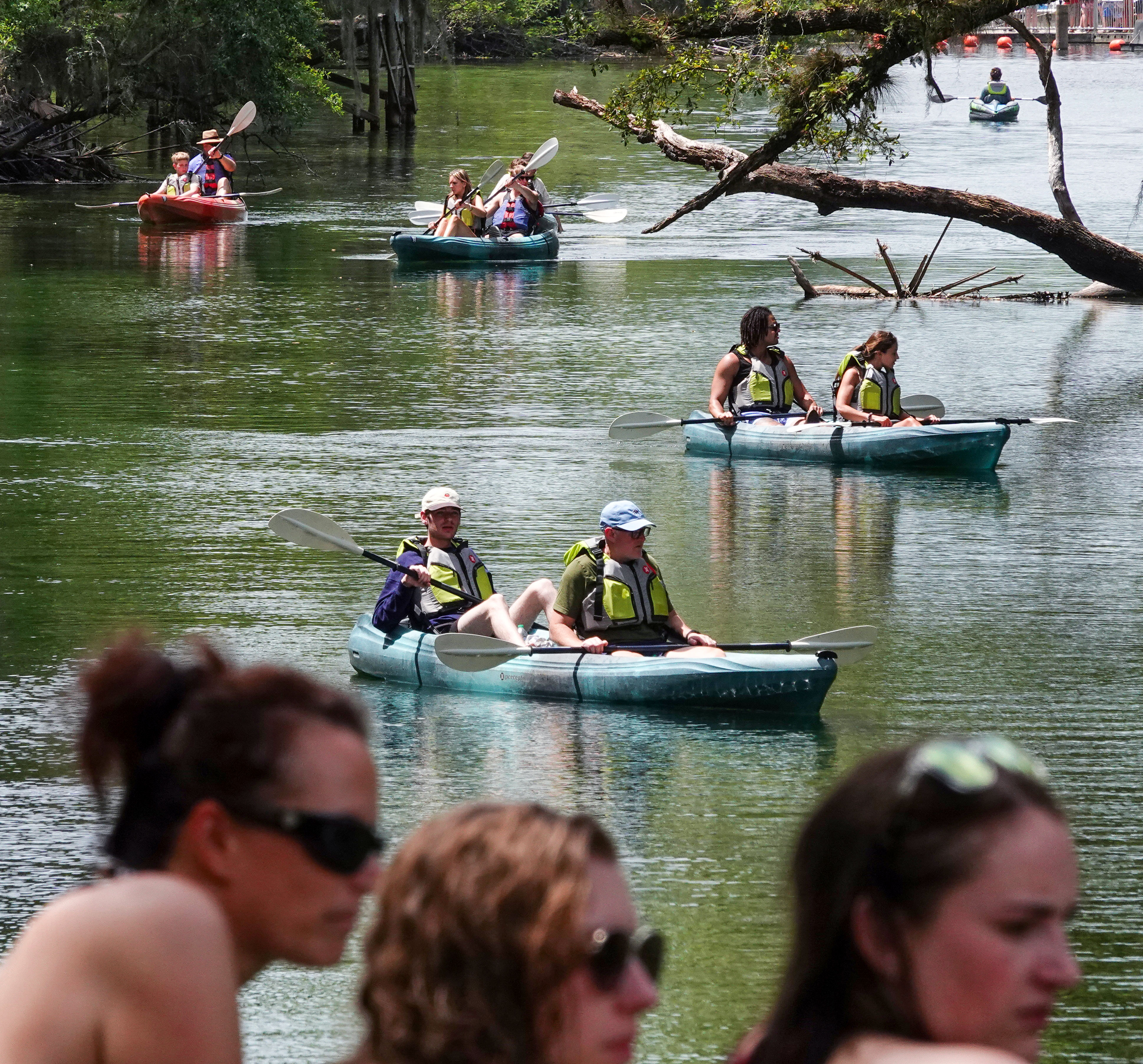 ENJOYING THE BLUE â Kayakers navigate up the run at...