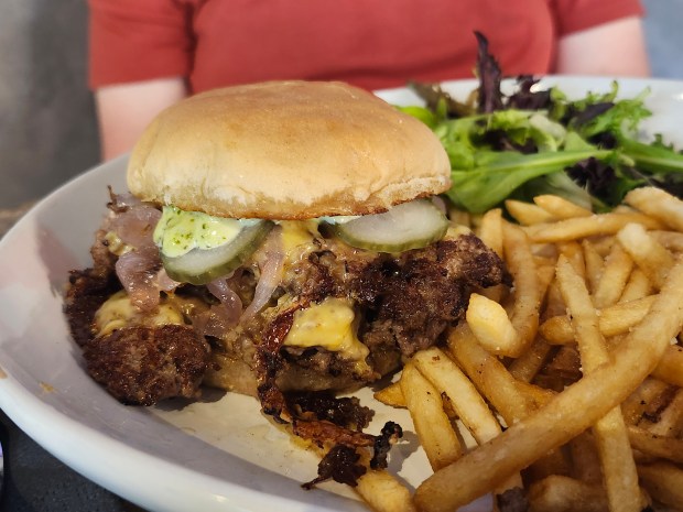 You don't have to be good, though. This is the Black Coffee Smash Burger, layered with with melted American cheese, sweet onions, and cilantro mayonnaise and served on a brioche buns with fries. Really solid. (Amy Drew Thompson/Orlando Sentinel)
