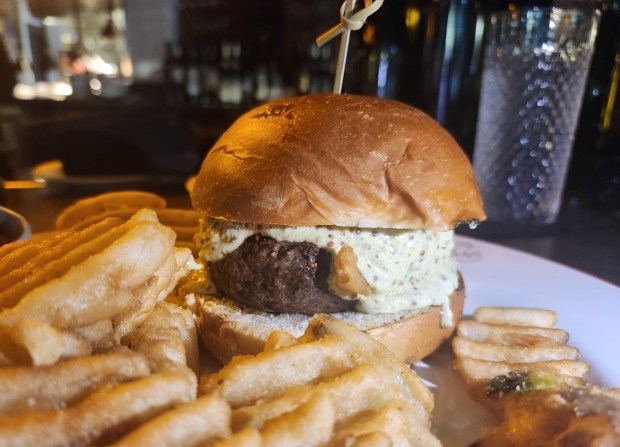 The bar- and brunch-only Corner Steak Burger is one of the best reasons to hang out at the bar. The $10 Social Hour martini is another. (Amy Drew Thompson/Orlando Sentinel)