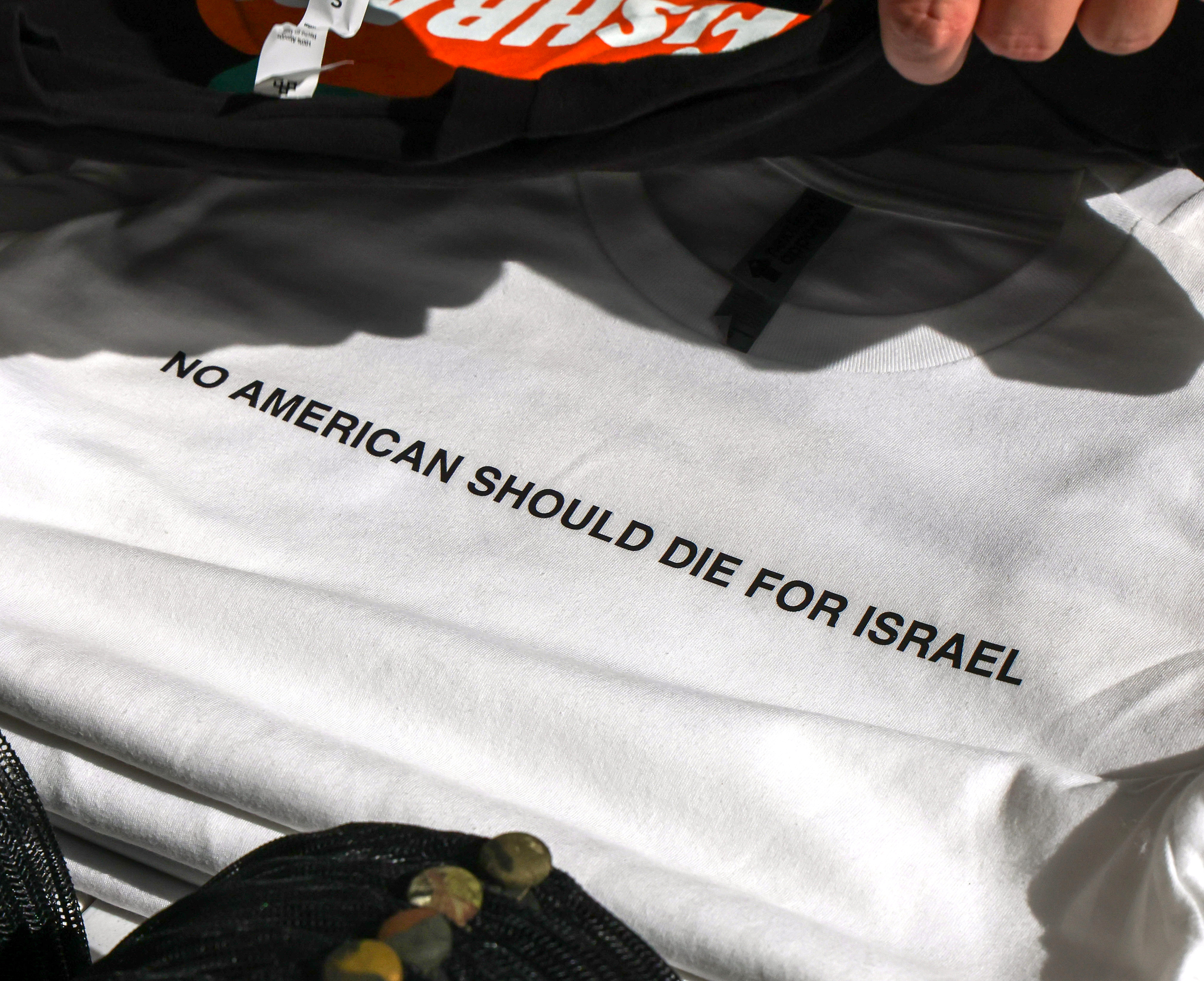 A âNO AMERICAN SHOULD DIE FOR ISRAELâ t-shirt on sale...
