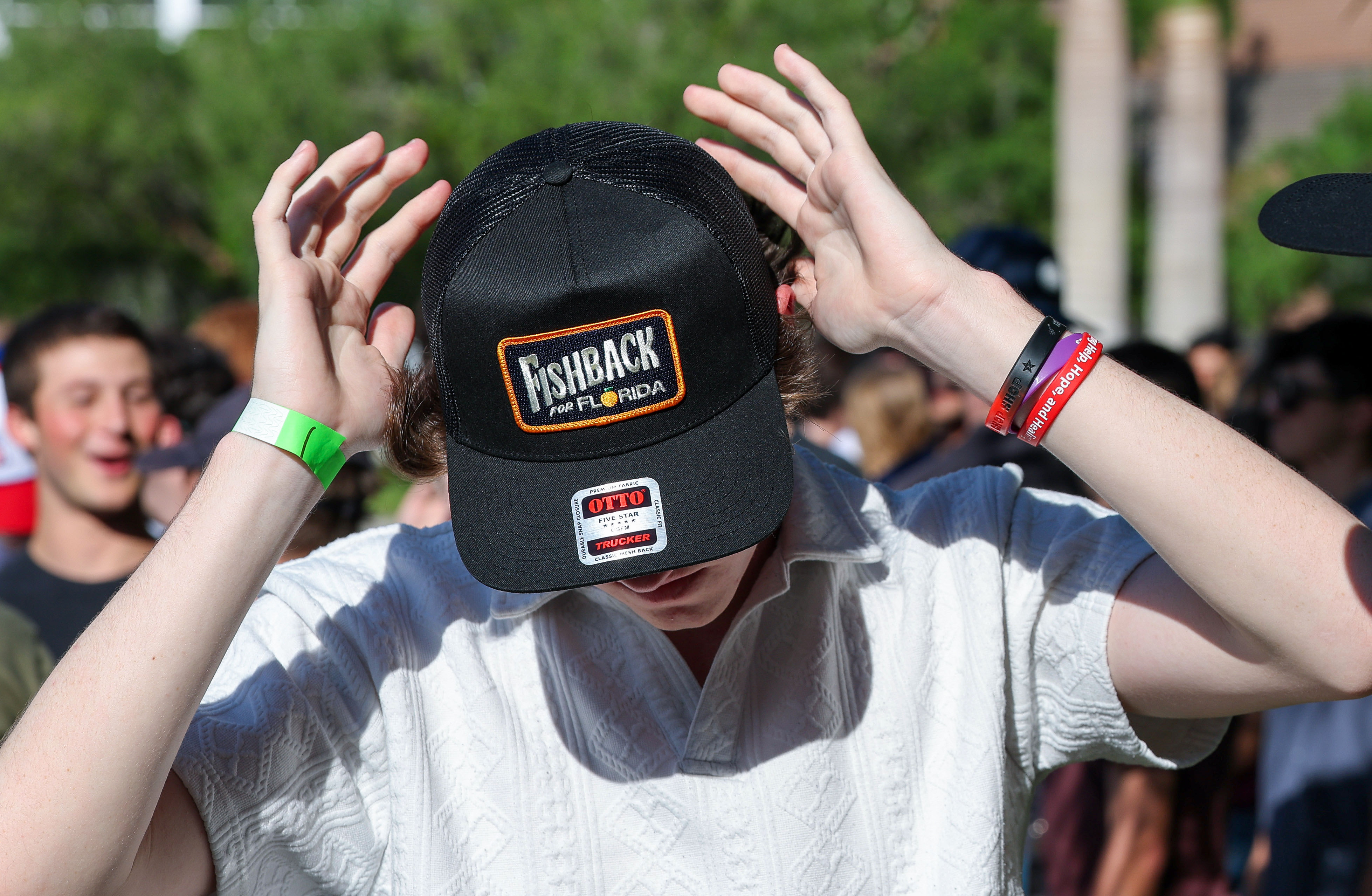 A supporters dons a campaign hat he bought during the...