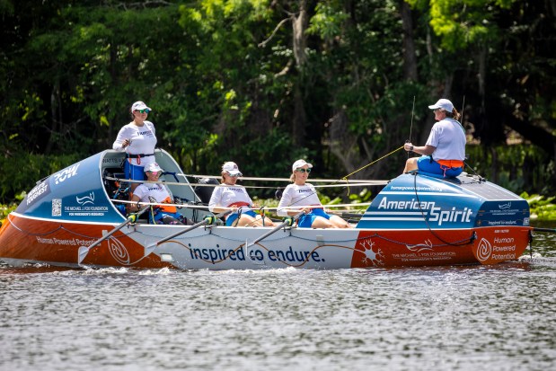 Rowers, from left, Andrea Vigil, Elizabeth Hall, Maureen Twohig, Ashley Ellis and Megan Laughlin row together on the American Spirit boat past Blue Spring State Park in Volusia County on April 19, 2026. The team plans to row more than 5,000 miles to raise money for Parkinson's research. (Patrick Connolly/Orlando Sentinel)
