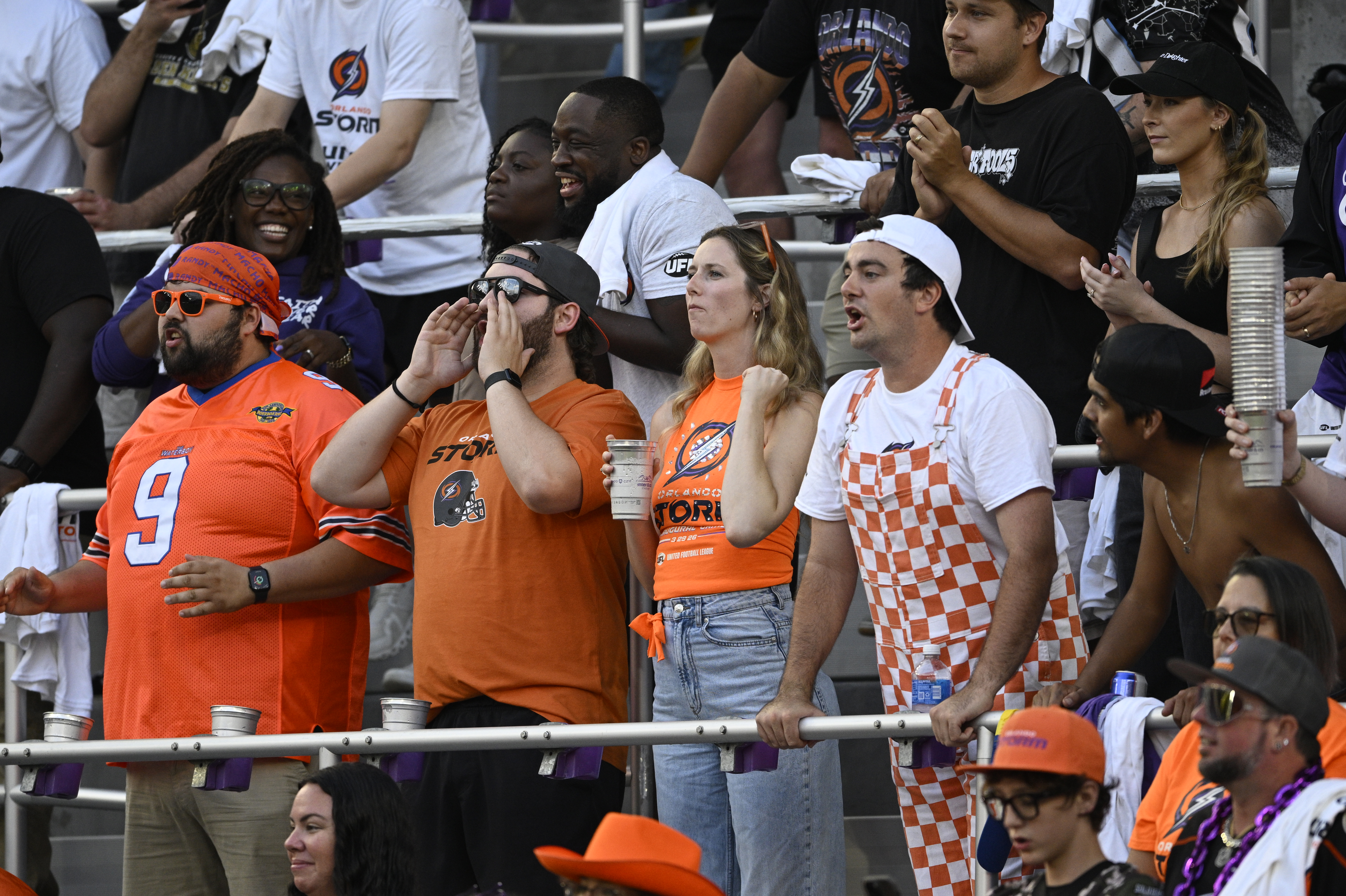 Fans cheer in the stands during a UFL football game...