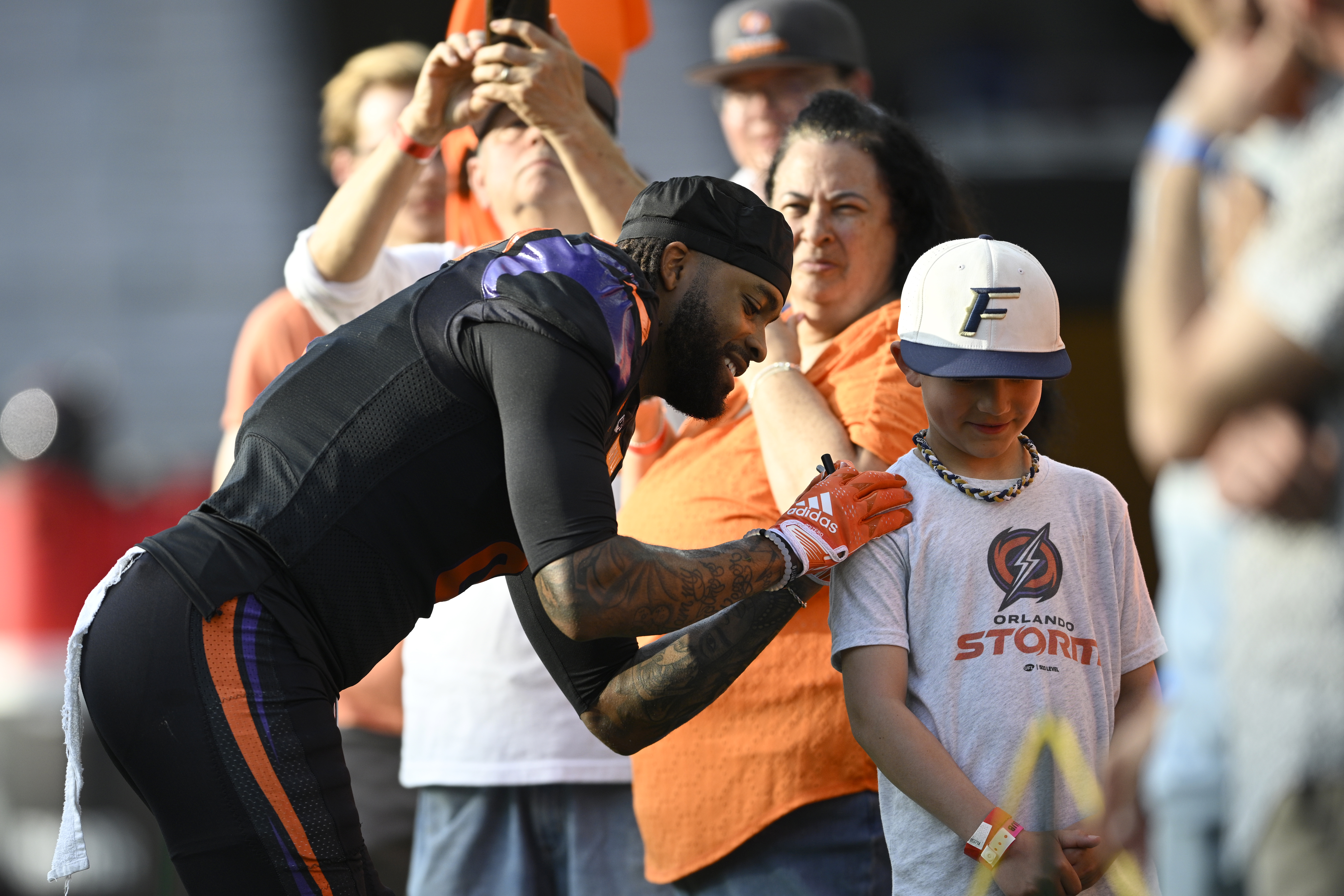Orlando Storm cornerback Mark Gilbert, left, signs an autograph for...