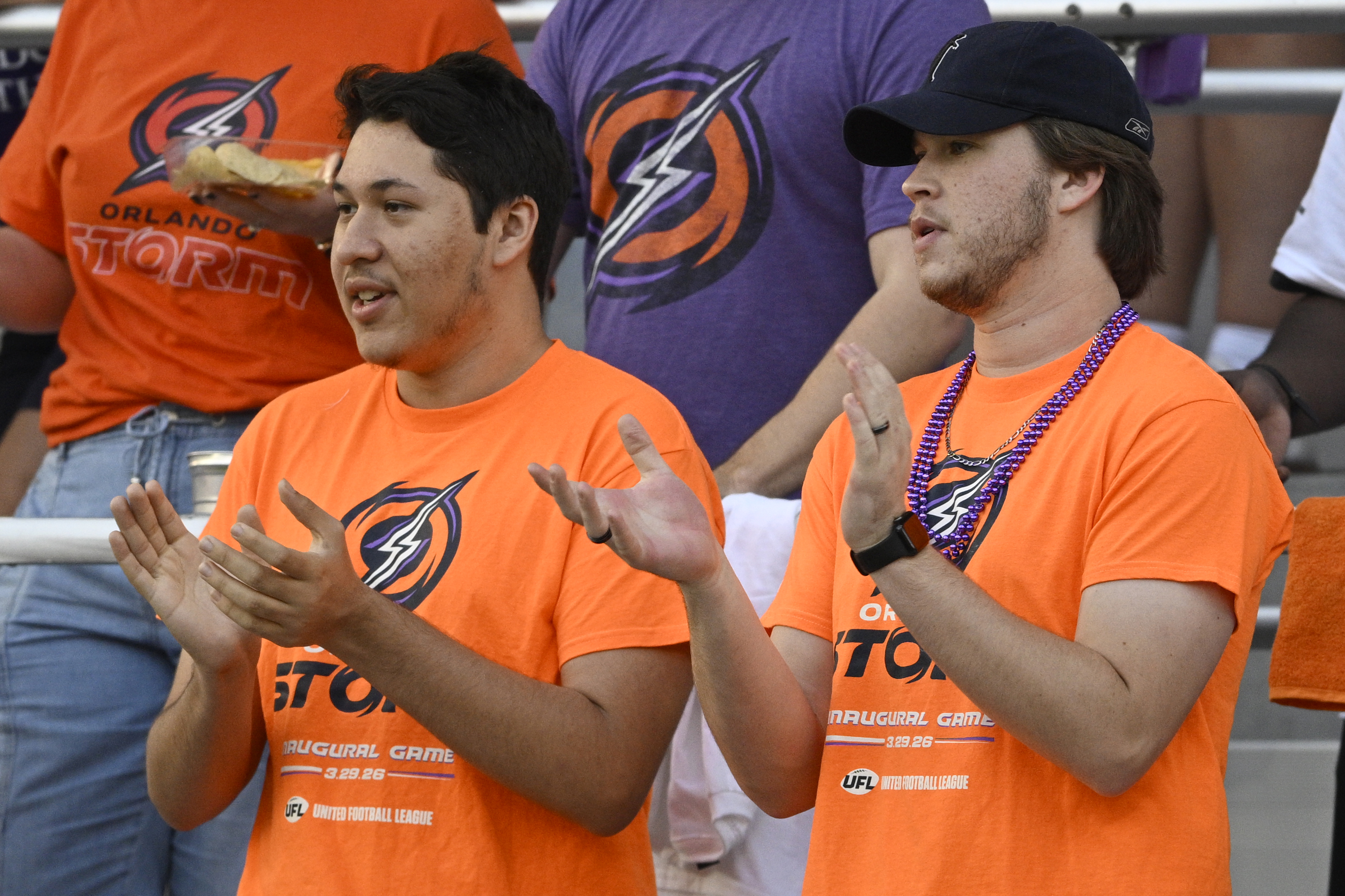 Fans cheer in the stands during a UFL football game...