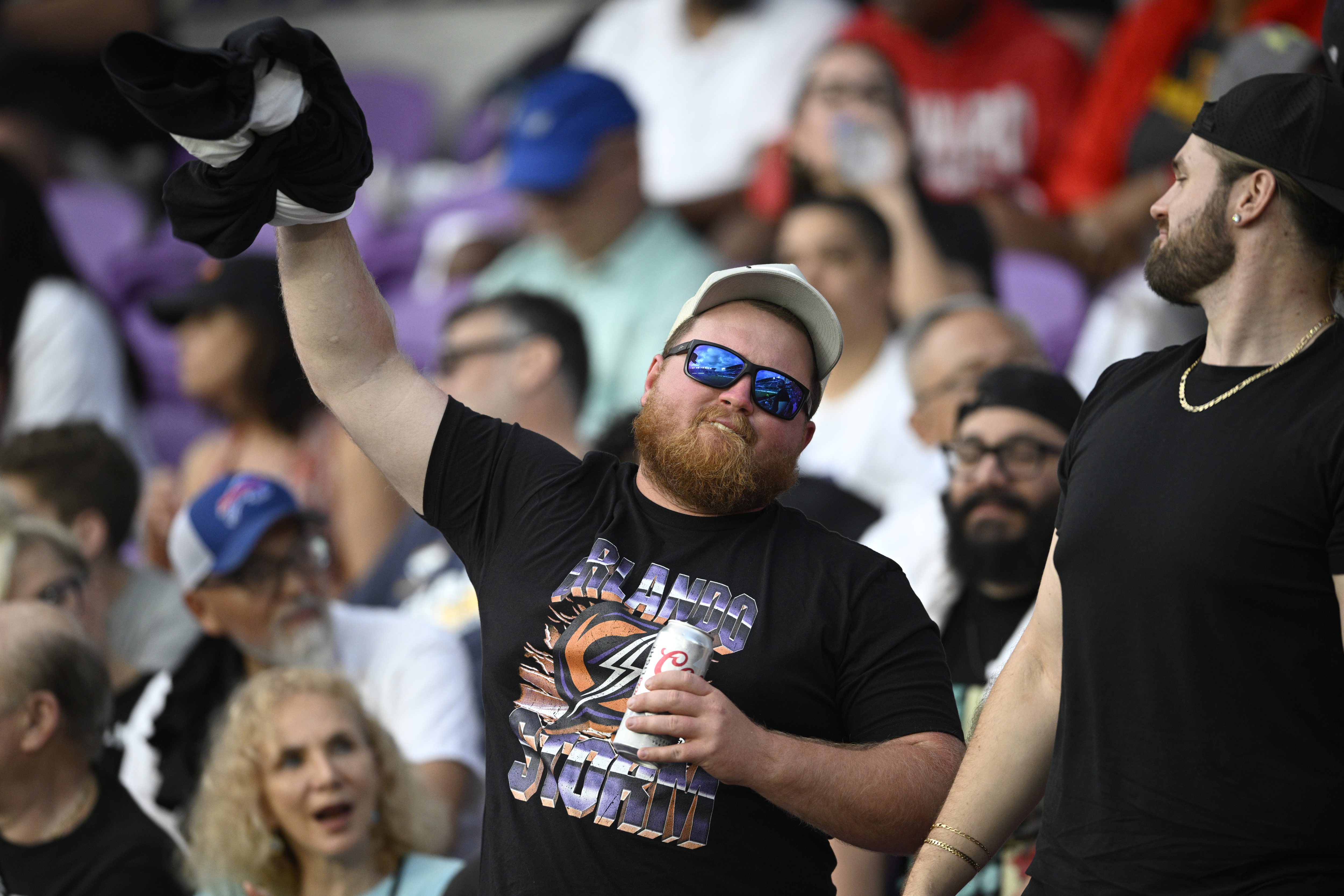 Fans cheer in the stands during a UFL football game...
