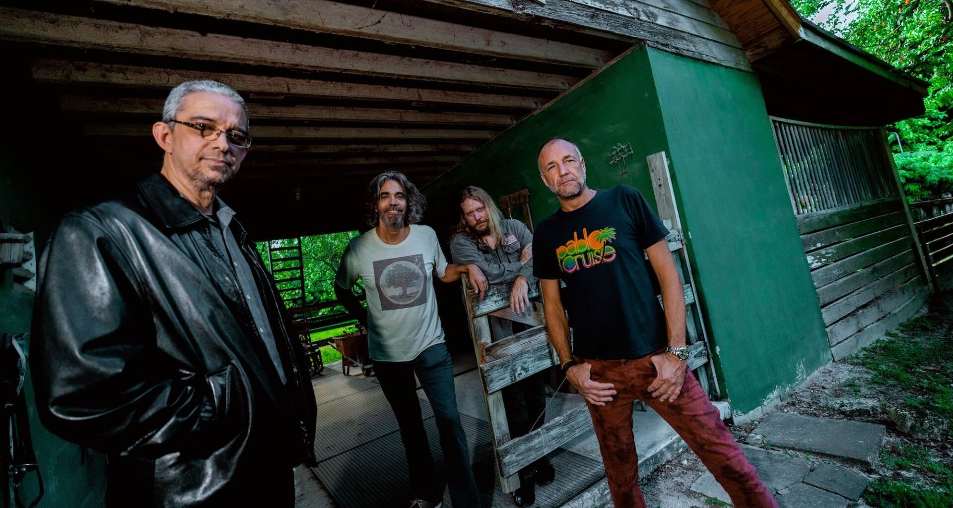 Photo of a band posing for the camera in Miami