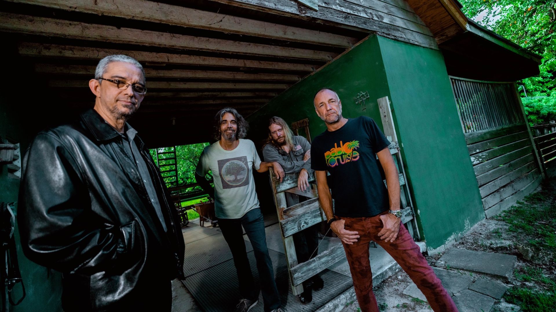 Photo of a band posing for the camera in Miami