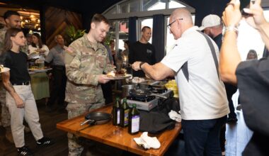 Chef Robert Irvine serves a meal to a U.S. service member during a Tampa Bay Wine & Food Festival event.