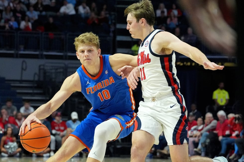 Florida forward Thomas Haugh (10) dribbles past Mississippi guard Travis Perry (11) during the...
