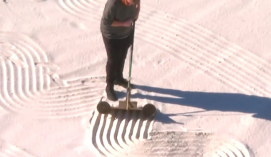 This man is creating sand art before dawn in Florida