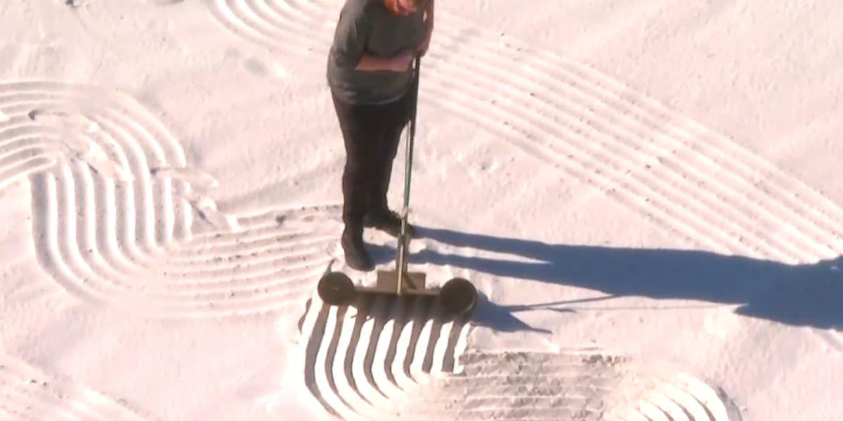 This man is creating sand art before dawn in Florida