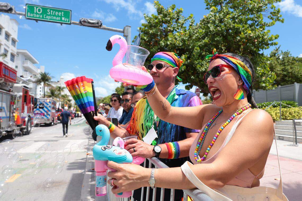 Mari Sherrer reacts while holding a plastic cup during the 18th annual pride parade in Miami Beach, Florida, Sunday, April 12, 2026.