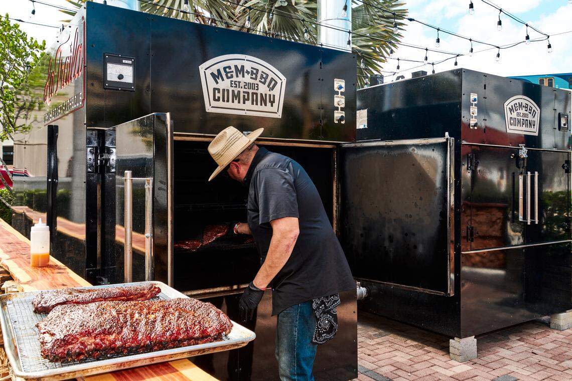 Mel Rodriguez removes meat from the smokers at La Traila Barbecue.