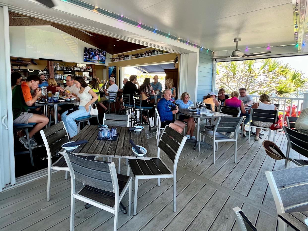 We love to settle in at High Tide Social House's open-air bar and front porch area.