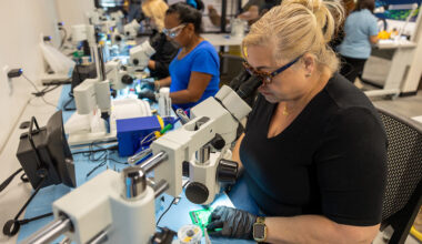 group of women working at soldering stations