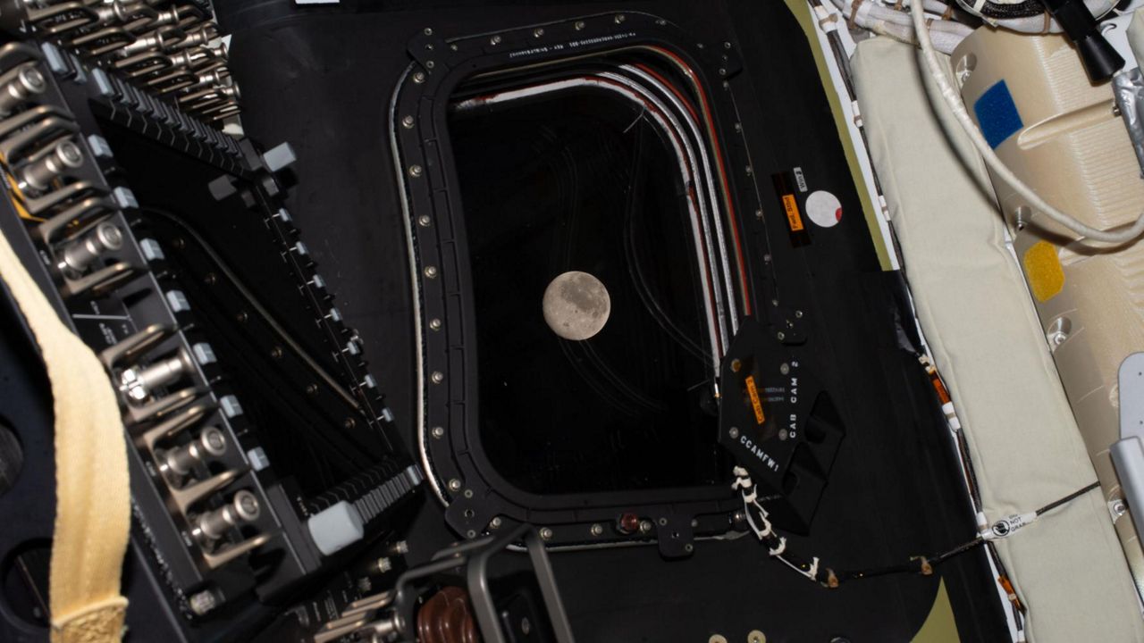 Before going to sleep on flight day 5, the Artemis II crew snaps one more photo of the moon as it drew close in the window of the Orion spacecraft. (NASA)