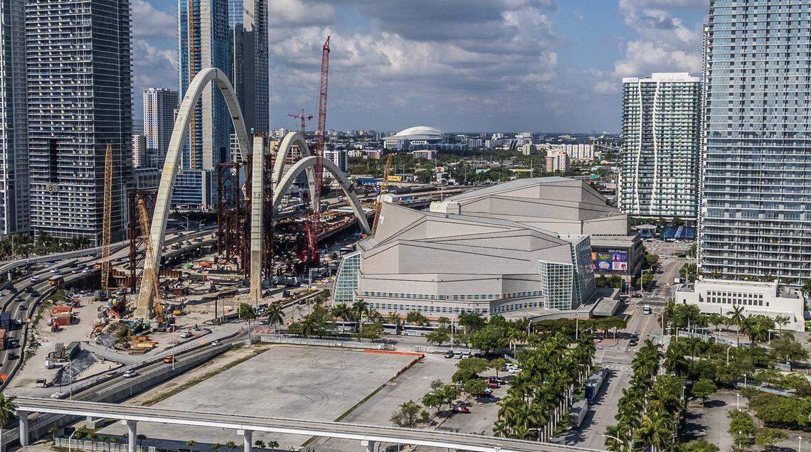 The arches for the Interstate 395 “signature bridge” over Biscayne Boulevard rise in front of Arsht Center, at right, in downtown Miami.