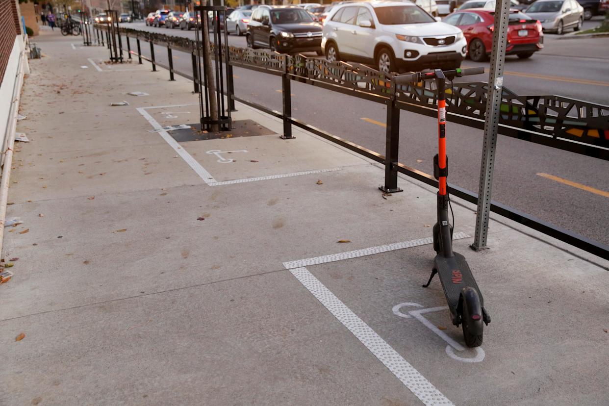 A lone Spin scooter sits in a parking space for motorized scooters, as seen in Lafayette, Indiana, in this 2019 file photo.