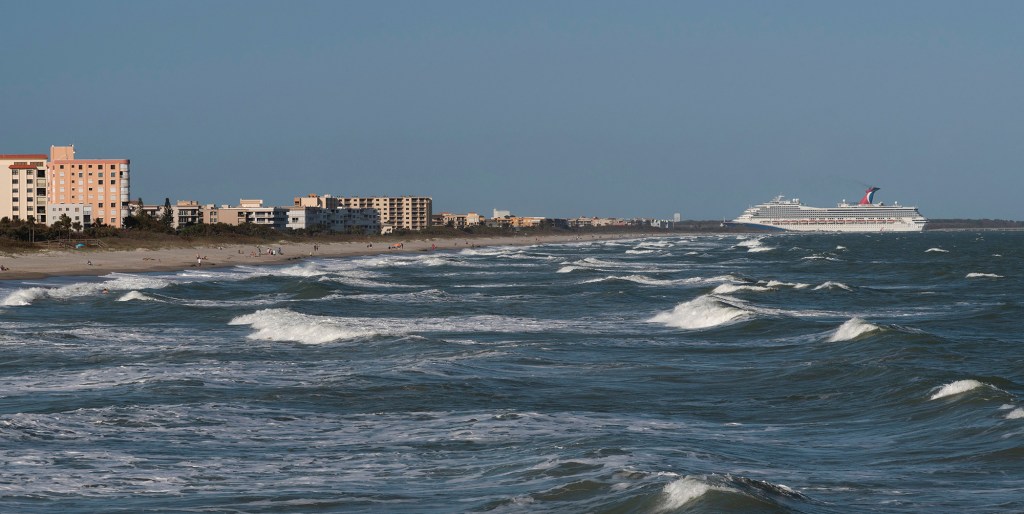 Cruise ship entering Port Canaveral from the Atlantic Ocean viewed from Cocoa Beach, Florida.