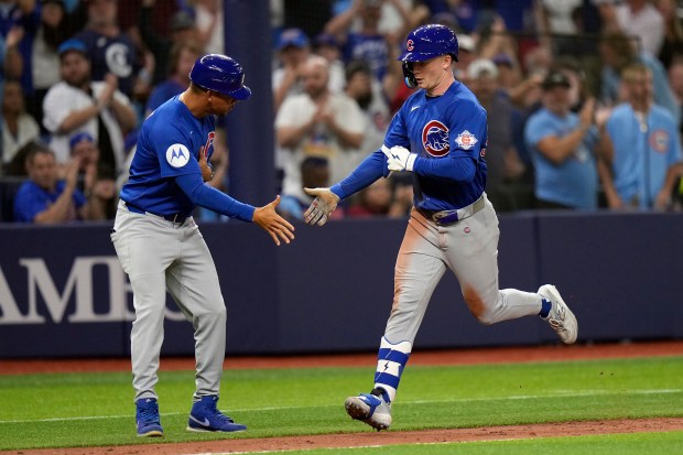 Chicago Cubs' Pete Crow-Armstrong celebrates with third base coach Quintin Berry after his solo home run off Tampa Bay Rays pitcher Yoendrys Gómez during the seventh inning of a game Tuesday, April 7, 2026, in St. Petersburg, Fla. (AP Photo/Chris O'Meara)