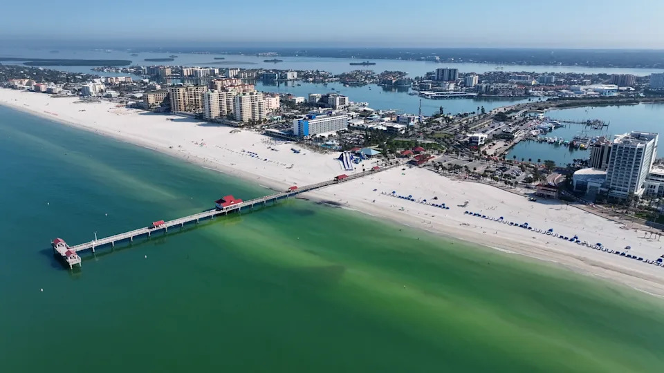 Clearwater Beach from above, showing the wide white-sand shoreline and bright Gulf water that make this stretch of Florida a classic resort base.