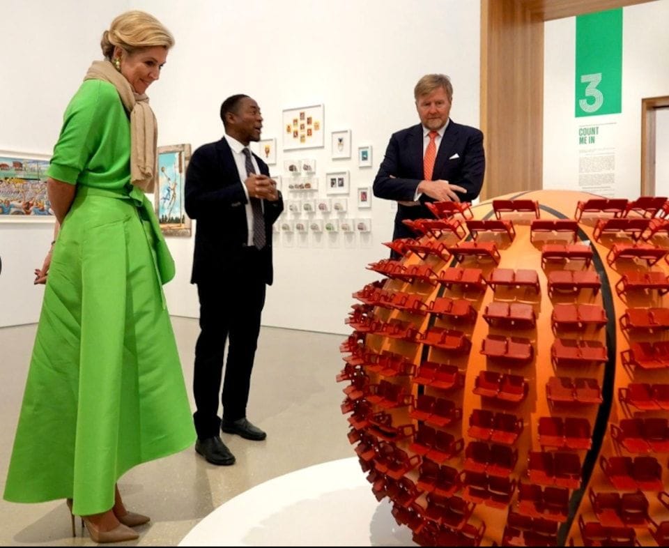 The Queen closely examining an object on display at the museum