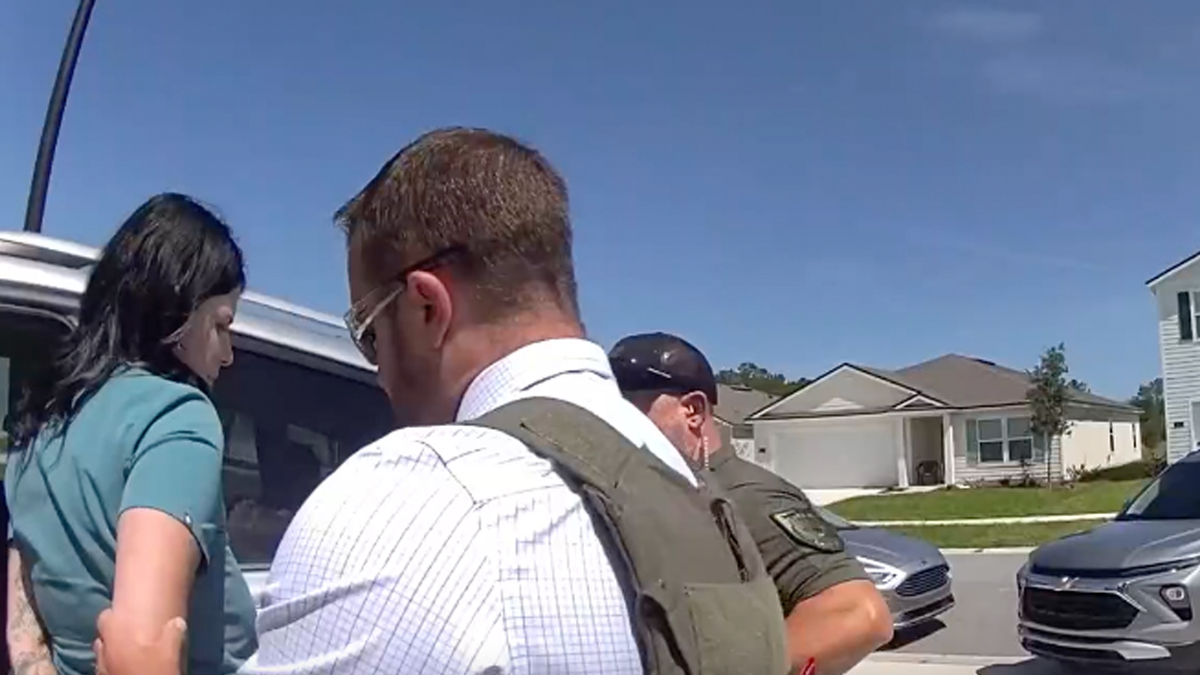 Autumn Bardisa wearing scrubs during arrest by Flagler County Sheriff's deputies