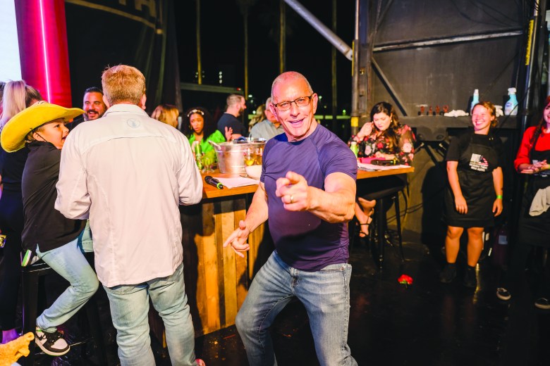 Robert Irvine points at the camera at a previous Tampa Bay Wine and Food Festival event