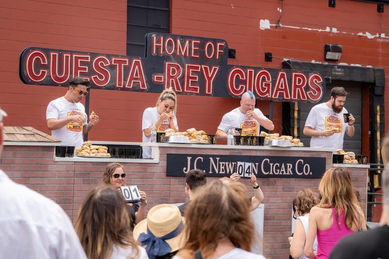 Four competetors in the J.C. Newman Cuban Sandwich Eating Challenge outside the historic Cuesta-Rey Cigars building.