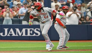 Cincinnati Reds' Elly de la Cruz (44) and third base coach Willie Harris celebrate de la Cruz's two run home run during the first inning of a baseball game against the Tampa Bay Rays Tuesday, April 21, 2026, in St. Petersburg, Fla. (AP Photo/Jason Behnken)