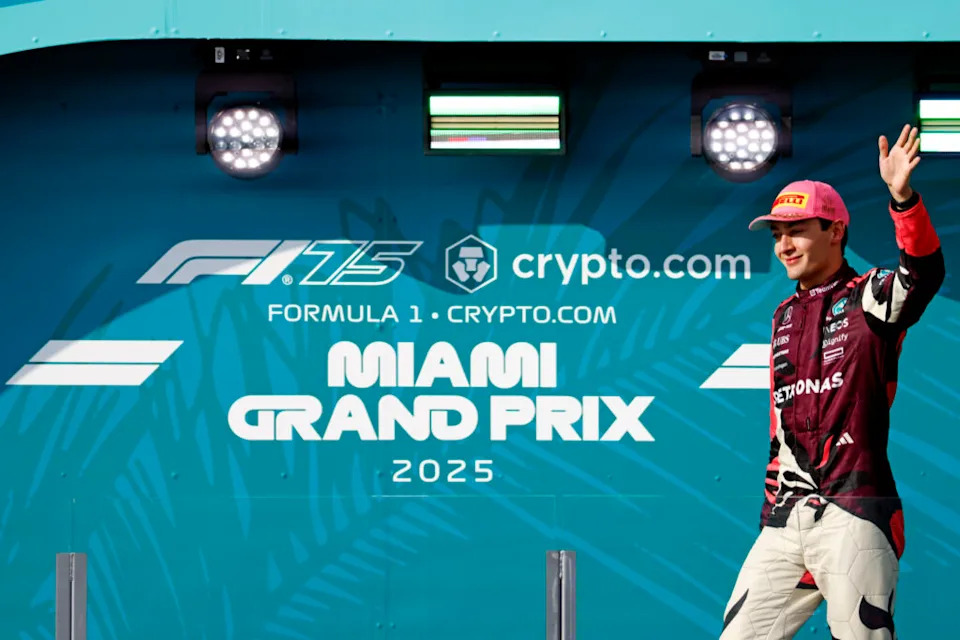May 4, 2025; Miami Gardens, FL, USA; Mercedes driver George Russell (63) walks to the podium after finishing third in the F1 Miami Grand Prix at Miami International Autodrome. Mandatory Credit: Peter Casey-Imagn Images