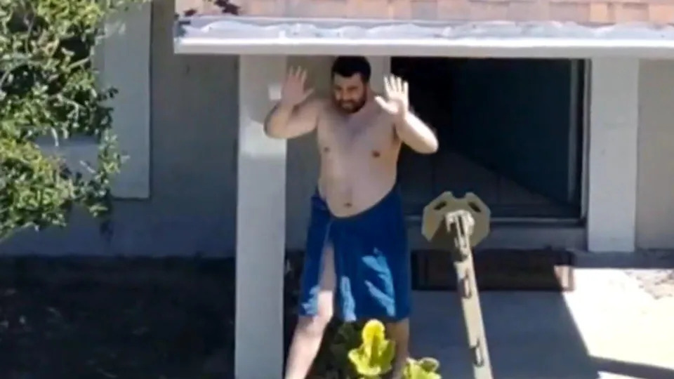 Hisham Abugharbieh with his hands raised prior to being taken into custody. / Credit: Hillsborough County Sheriff's Office