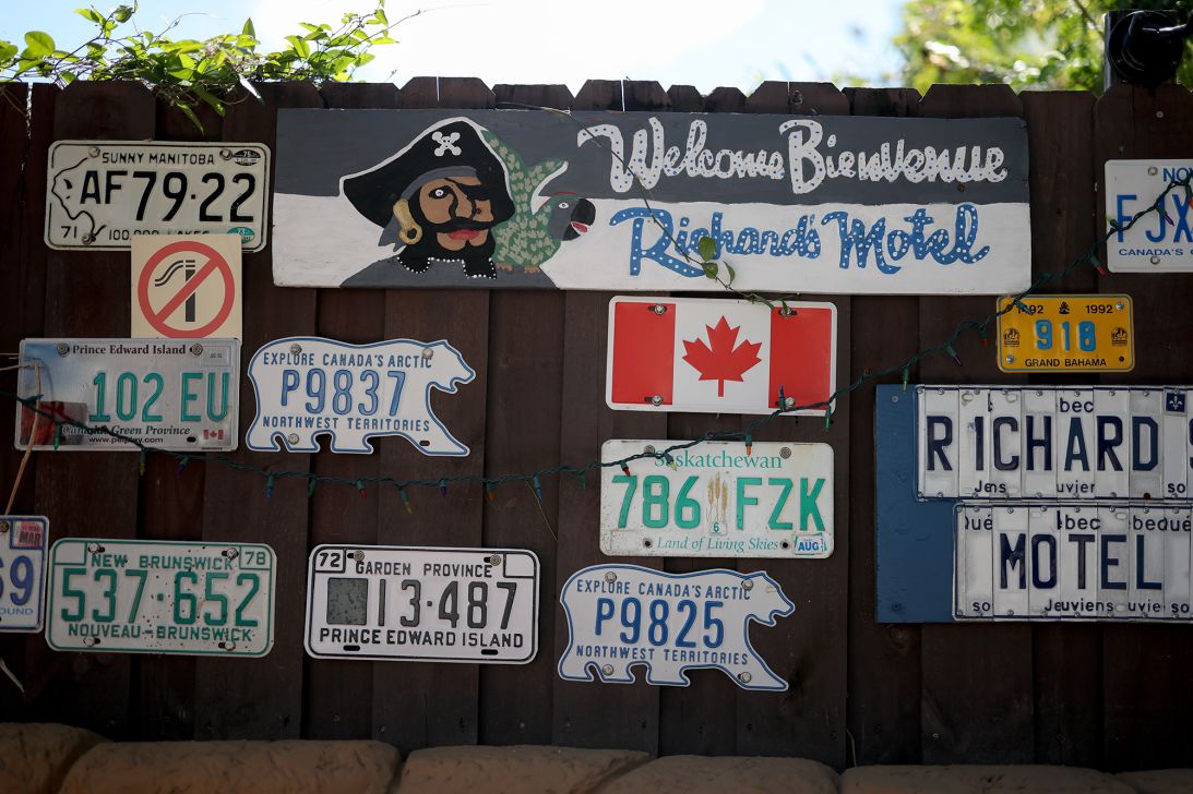 Canadian license plates hang on a wall at Richard's Motel. Owner Richard Clavet, who voted for President Donald Trump, said tensions between the US and Canada are keeping some Canadians away.