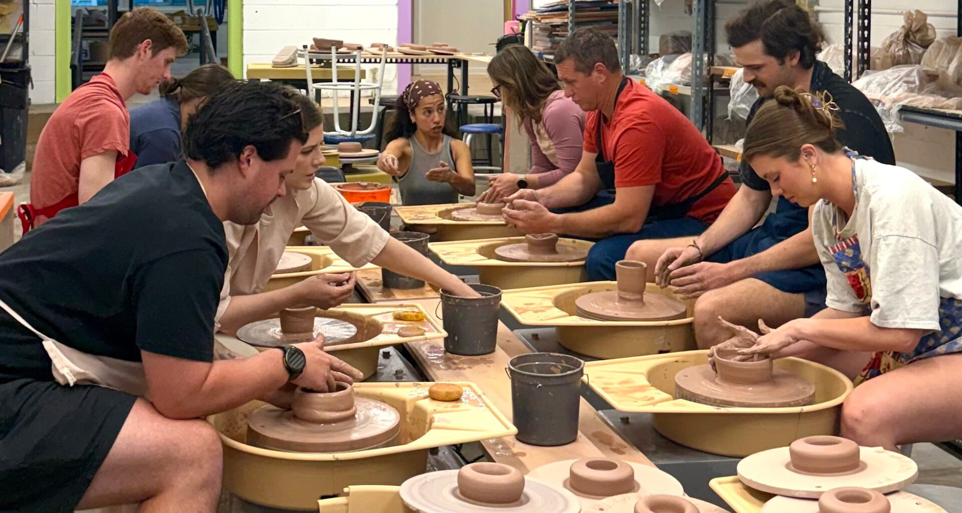 People molding clay