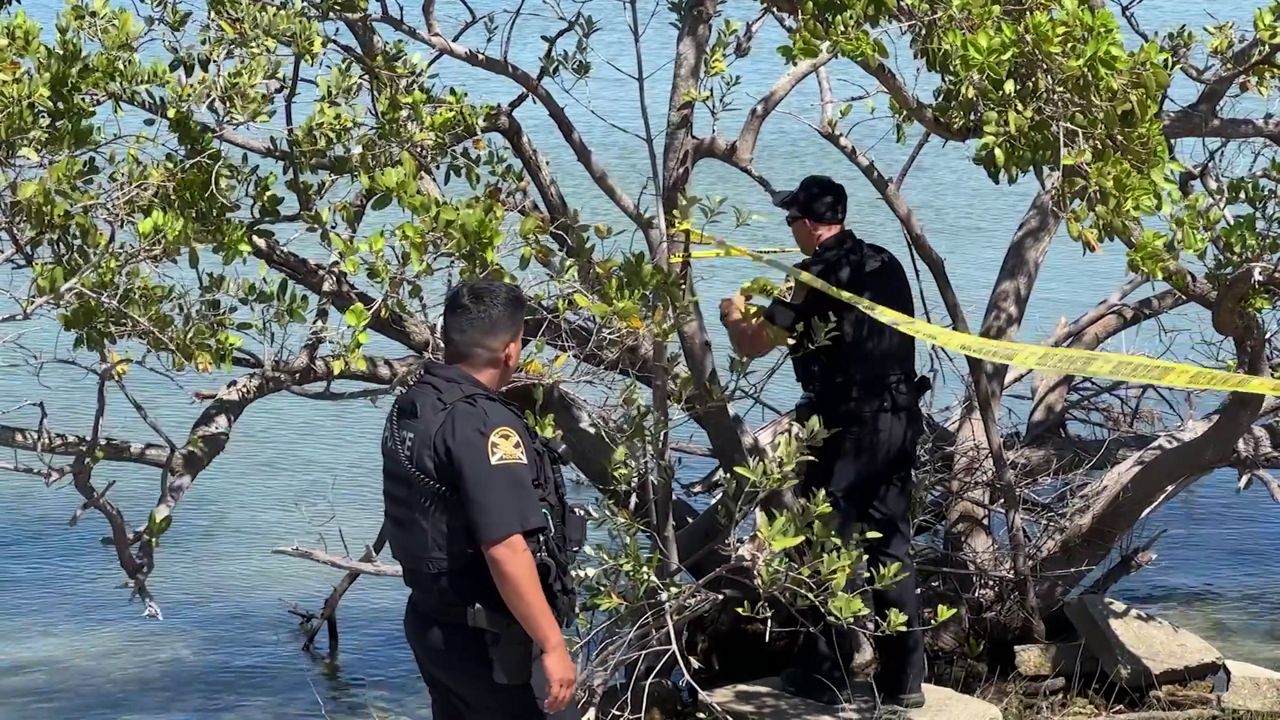 St. Petersburg Police Department officers put caution tape around an area near I-275 and 4th Street where human remains were discovered on Sunday. (Spectrum News/Matt Lackritz)