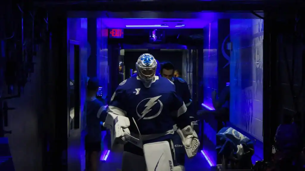 A hockey goalie coming out of a tunnel