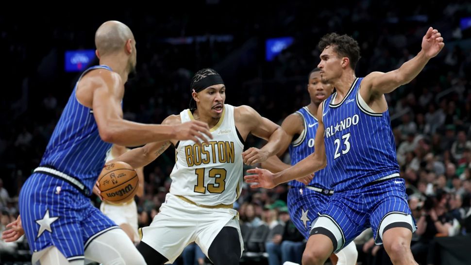 Boston Celtics forward Ron Harper Jr. (13) drives to the net as Orlando Magic forward Tristan da Silva (23) defends during the first half of an NBA basketball game, Sunday, April 12, 2026, in Boston. (AP Photo/Mark Stockwell)