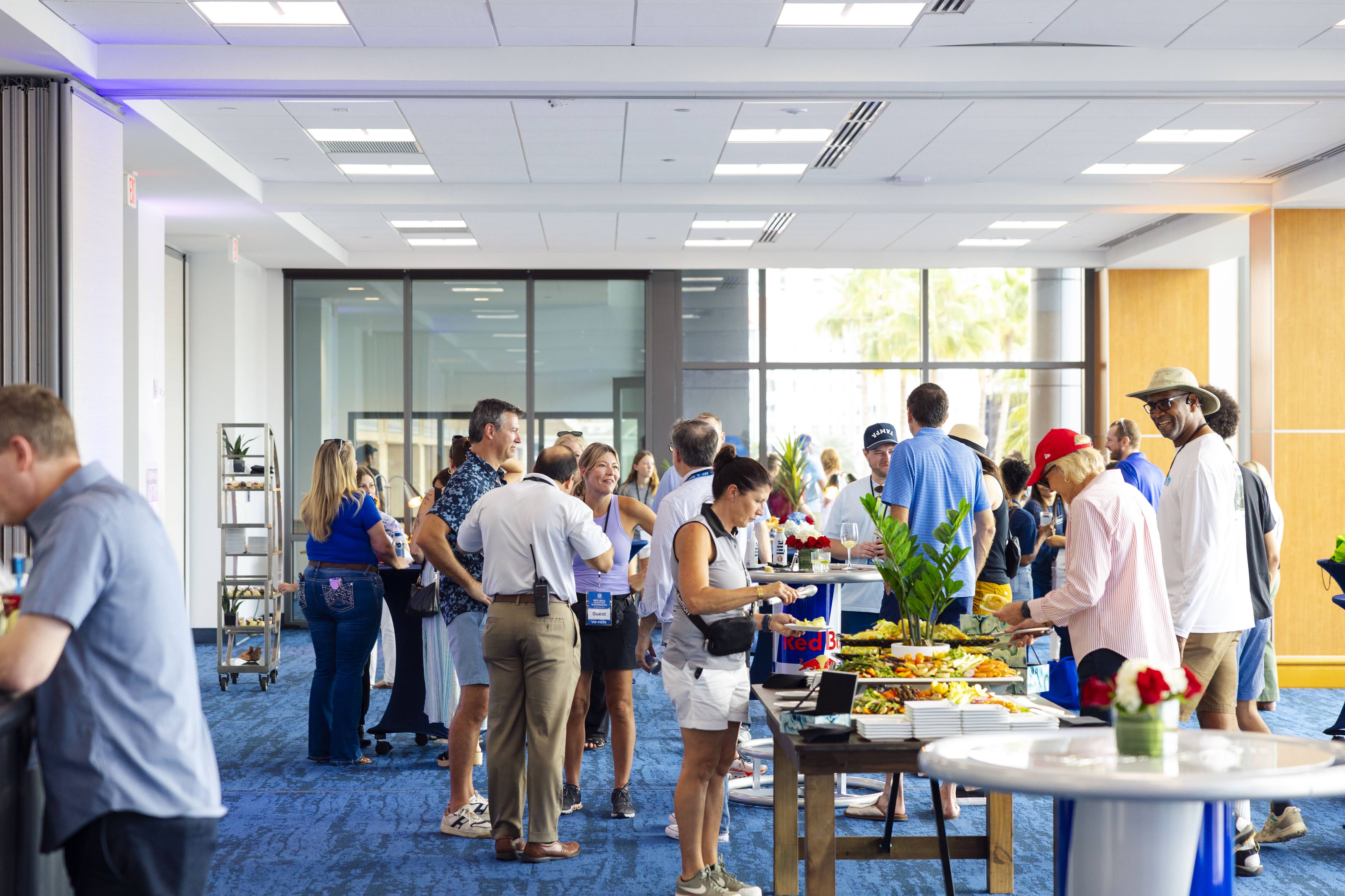 Interior of waterfront meeting room at the Tampa Convention Center with floor-to-ceiling windows and catering food spread.