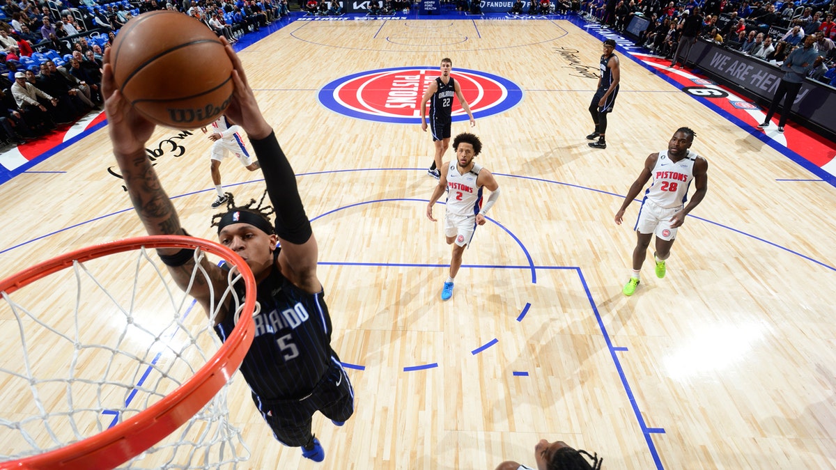 Paolo Banchero driving to the basket during an NBA game at Little Caesars Arena
