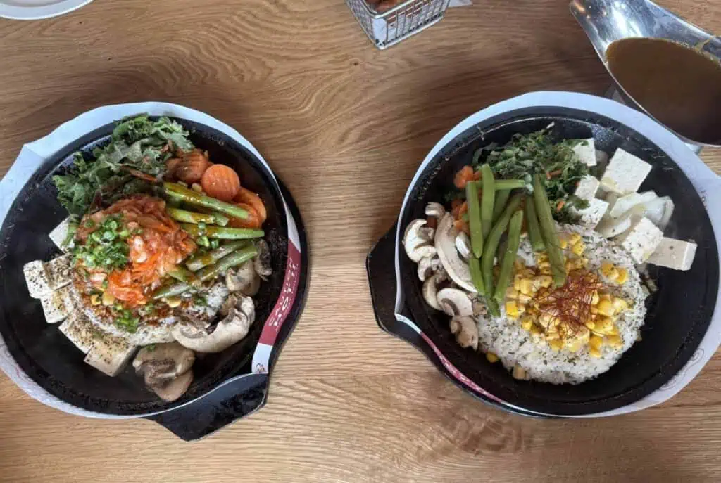 Two plates of noodle dishes