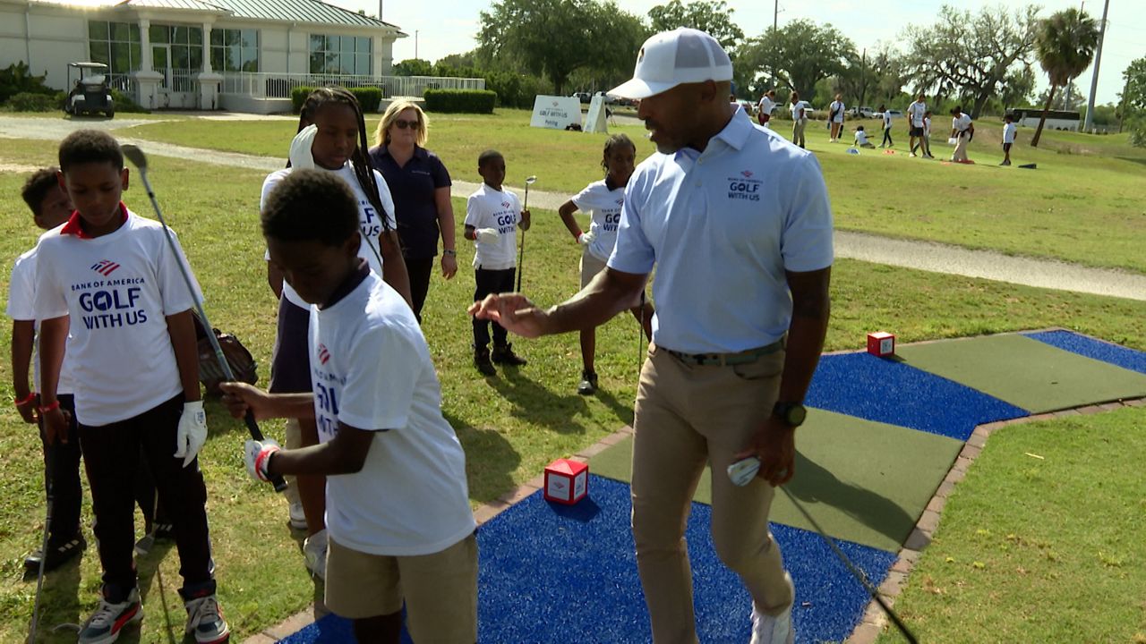 Ronde Barber teaches kids about golf as the Boys and Girls Clubs of Tampa Bay hosted the Bank of America's "Golf With Us" clinic. (Michael Epps - Spectrum Sports 360)