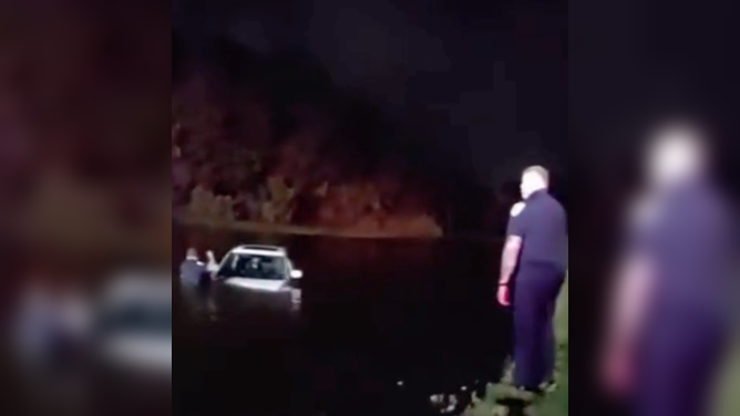 Port St. Lucie Police officers rescue an elderly couple from a vehicle that became partially submerged in a pond after crashing during heavy downpours on April 8.