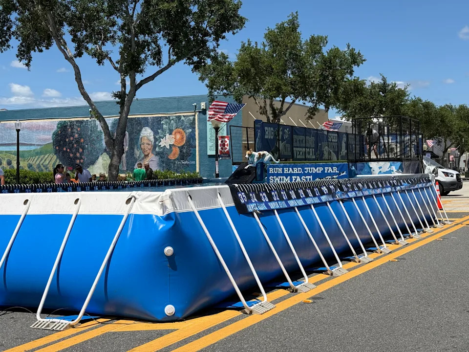 Dog jumping into competition pool.