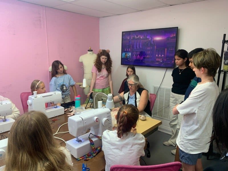 Children learning how to sew