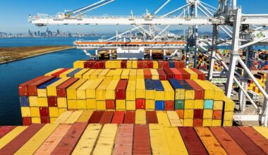 Cargo containers line a ship at the Port of Oakland. (AP Photo/Noah Berger, File)