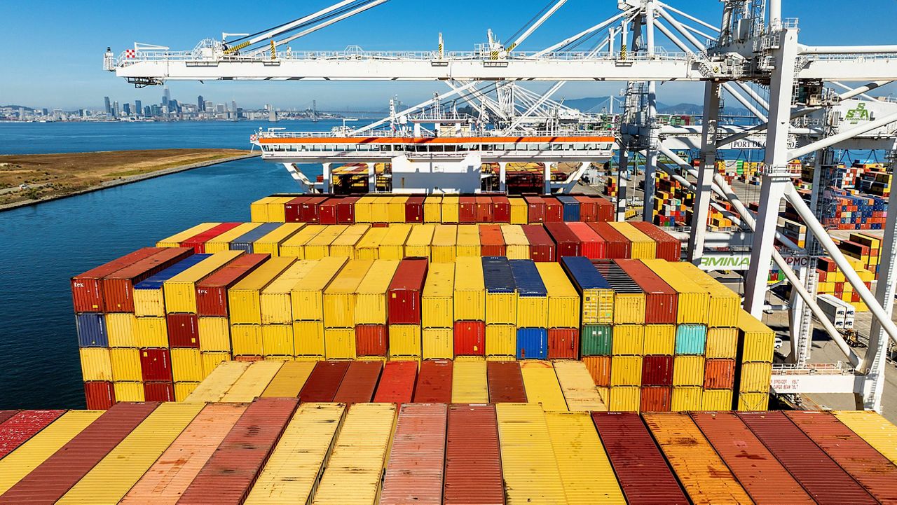 Cargo containers line a ship at the Port of Oakland. (AP Photo/Noah Berger, File)