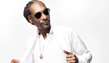 Photo of Snoop Dog wearing a white suit. He will be performing in Miami for Race Week.