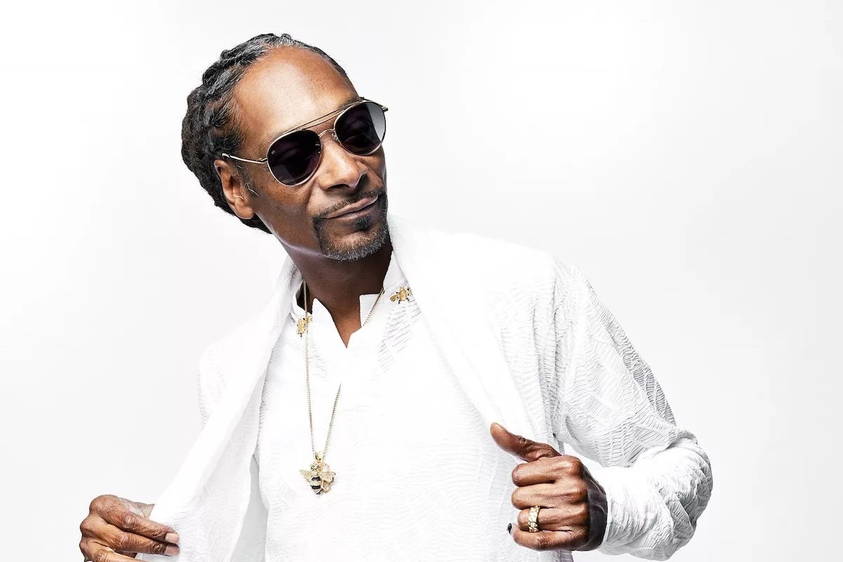 Photo of Snoop Dog wearing a white suit. He will be performing in Miami for Race Week.